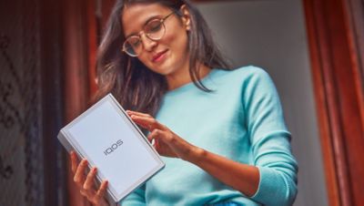 Una mujer abriendo un paquete de IQOS