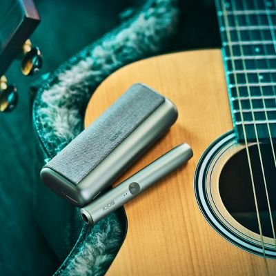 A Jade Green IQOS ILUMA PRIME Holder and Pocket Charger.