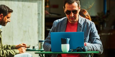 Hands unboxing an IQOS device.