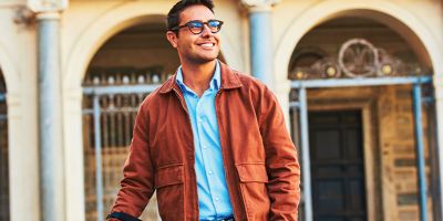 One person handing an IQOS device box to a smiling woman.