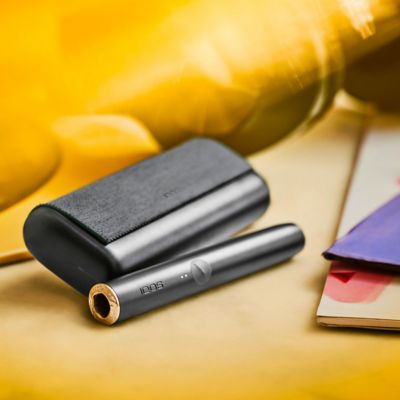 Girl showing a gold IQOS holder