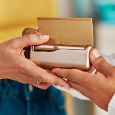 Girl looking at her IQOS device