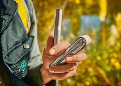 Group of friends with man holding an IQOS device