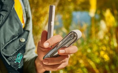 Group of friends with man holding an IQOS device