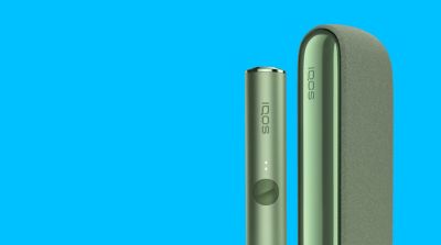 A Moss Green IQOS ILUMA device and Pocket Charger.