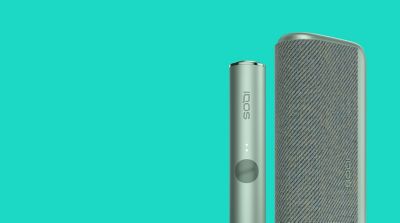 A Moss Green IQOS ILUMA device and Pocket Charger.