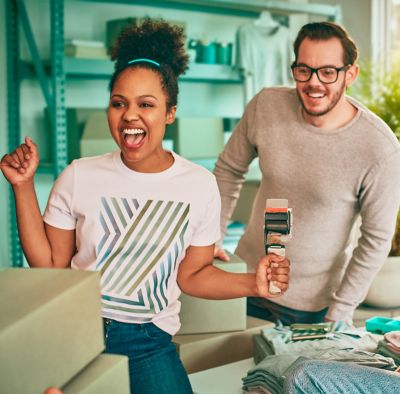 A woman holding an IQOS device box