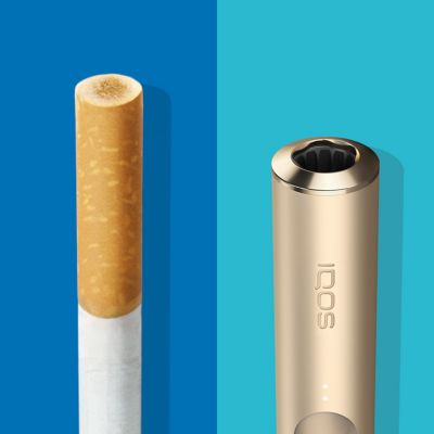 Cigarette filter with brown combustion stains compared to IQOS HEETS stick in IQOS 3 DUO holder with no equivalent stain