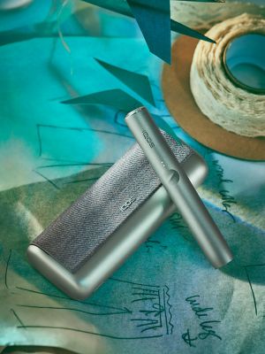 A pebble gray IQOS ILUMA device.