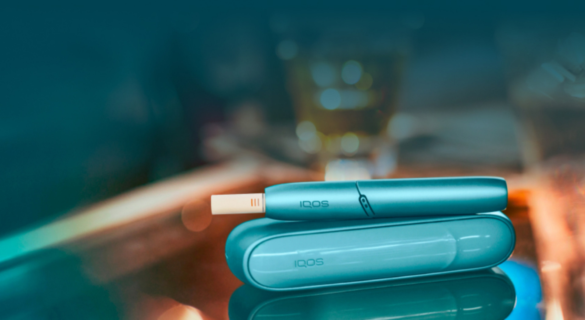 An IQOS ILUMA PRIME device, its jade green in colour