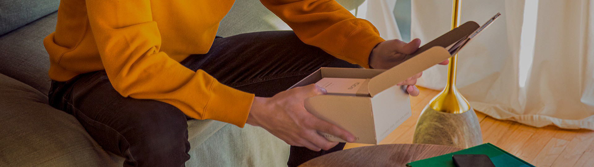 A close-up of a person unboxing their IQOS ILUMA device