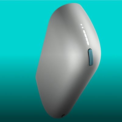 An IQOS ILUMA device in a charging station with a Pocket Charger on a table.