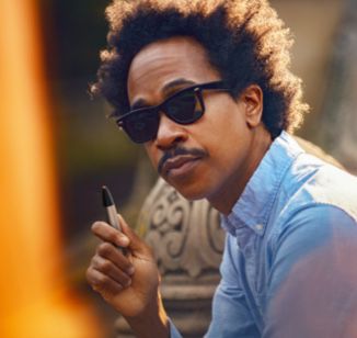 A man using an IQOS VEEV device.