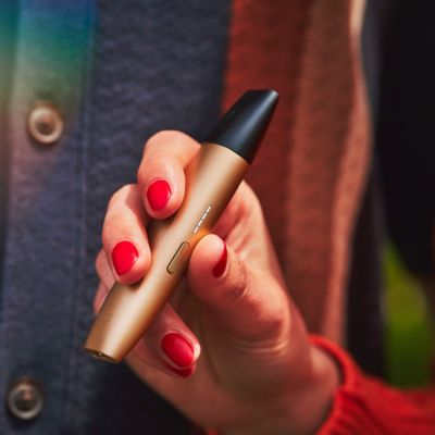 A man using an IQOS VEEV device.