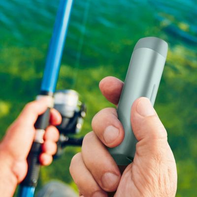 Hands holding lil SOLID Ez device and fishing gear