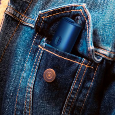 Blue BONDS 2 by IQOS device tucked into the chest pocket of a denim jacket