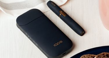 Black and white IQOS 2.4 Kit on a table