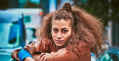 Woman with a golden IQOS holder and charger in her hand