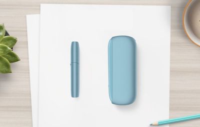 An IQOS ILUMA Pocket Charger in a charging station.