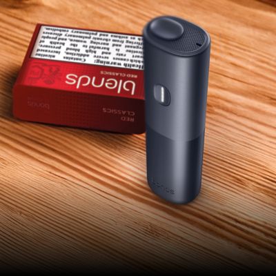 black BONDS 2 by IQOS device on a wooden table