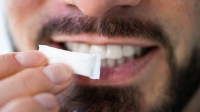Man holding up nicotine pouch