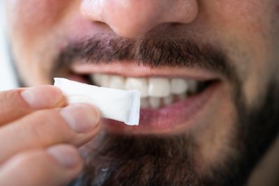 Man holding up nicotine pouch