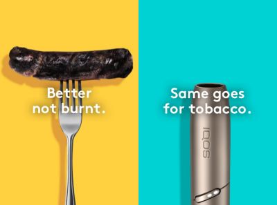 Burnt sausage on a fork compared to a clean IQOS HEETS stick in IQOS 3 DUO holder.