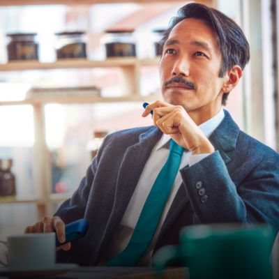 Business man with stellar blue IQOS holder and charger in hand