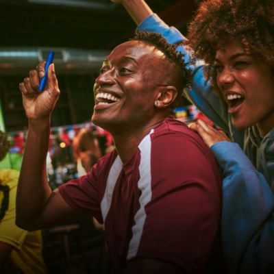 Man at event with IQOS holder in hand