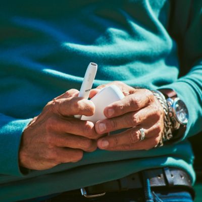 Brilliant gold IQOS 3 DUO holder in hand