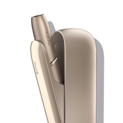 Brilliant gold IQOS 3 DUO holder in its charger.