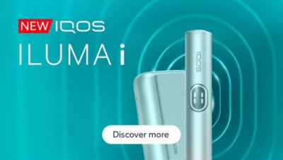 Close-up of an IQOS ILUMA i PRIME against a futuristic teal abstract background with radiating curved lines.