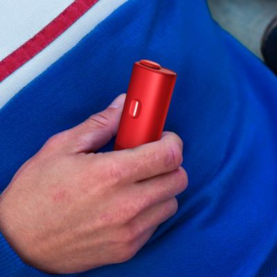 hand holding BONDS by IQOS Ruby Red