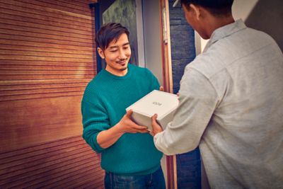 Woman looking at IQOS packaging