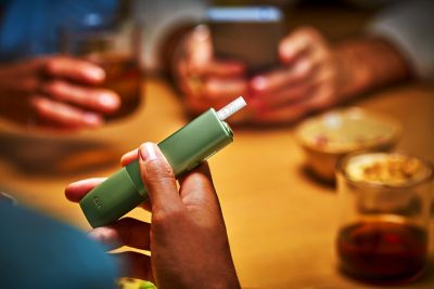 Man unboxing a new IQOS device.