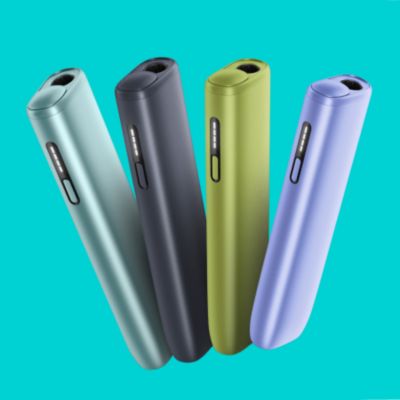 Woman holding an IQOS ILUMA ONE device