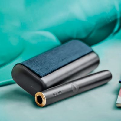 A person places a TEREA stick into an IQOS ILUMA PRIME Holder.