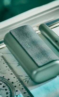 A jade green IQOS ILUMA PRIME Pocket Charger and Holder.