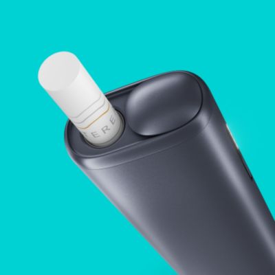 A Moss Green IQOS ILUMA ONE with a TEREA stick inserted.