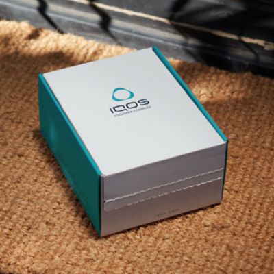 Stellar blue IQOS 3 DUO holder and charger on a music production panel