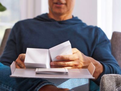 A man opening an IQOS box