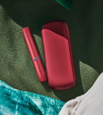 A blue IQOS device and holder.