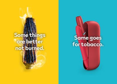 Burnt sausage on a fork compared to a clean IQOS HEETS stick in IQOS ORIGINALS DUO holder.