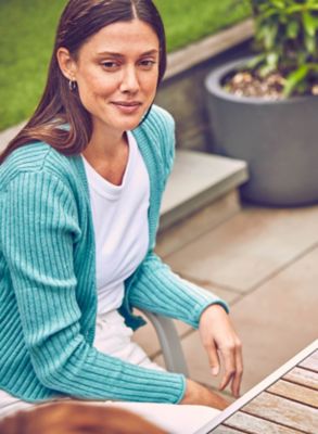 A mobile and a gold IQOS kit on a table