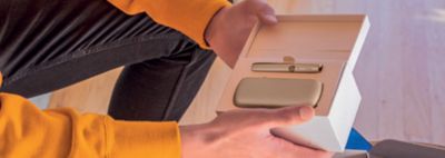 A man holding an IQOS box.