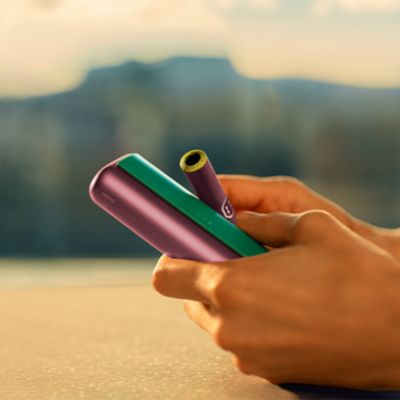 Man takes out his IQOS device from the packaging