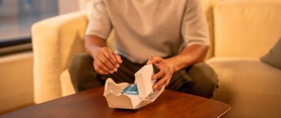 Man opening his gold IQOS device