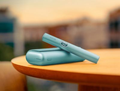 Man opening his gold IQOS device