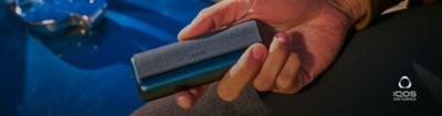 An ILUMA Prime charger held in hand