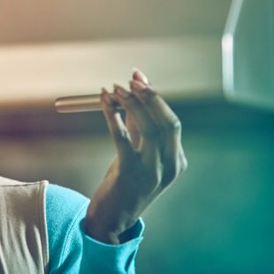 Girl showing a gold IQOS holder